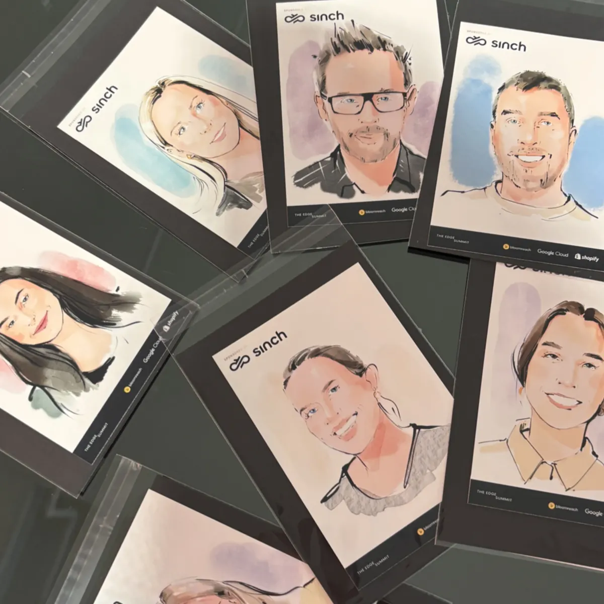 Finished guest portraits laid out on a table