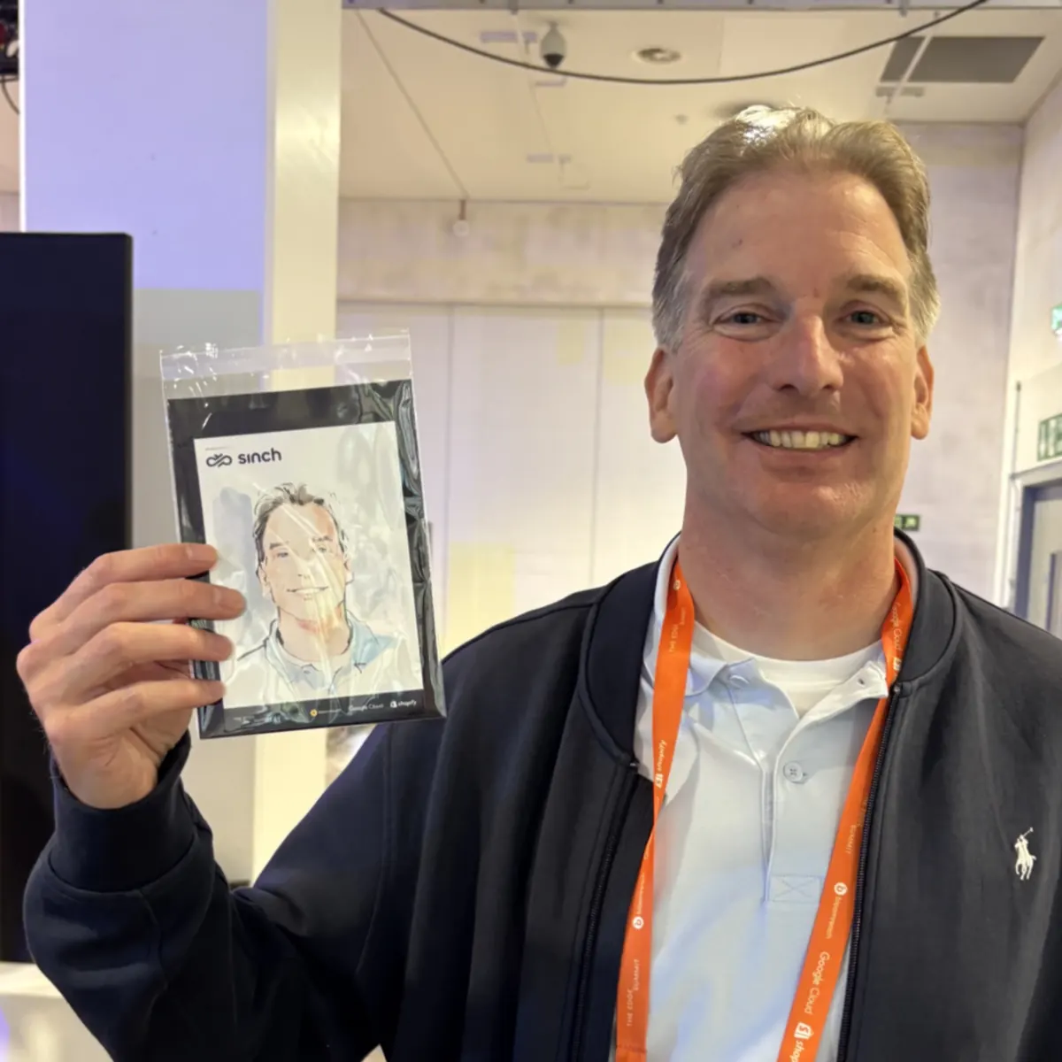 Guest holding his live portrait at a conference